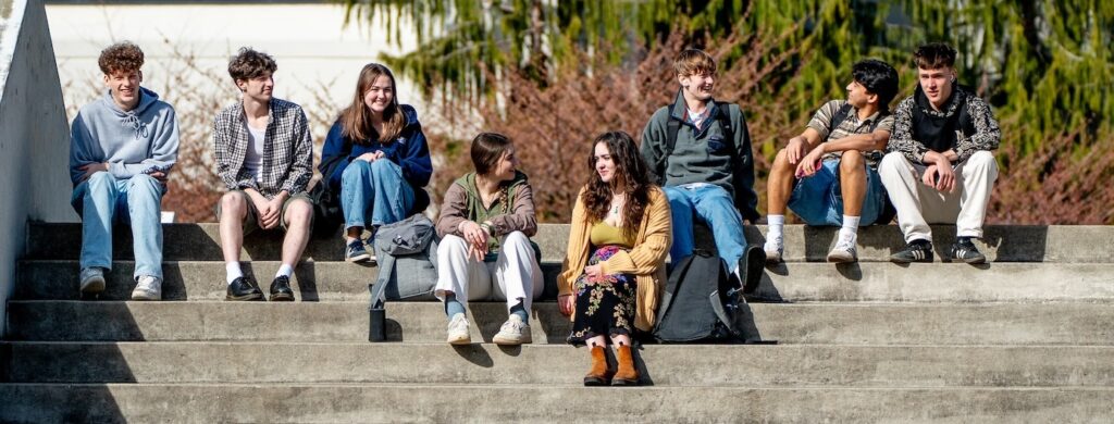 Students sitting on college steps